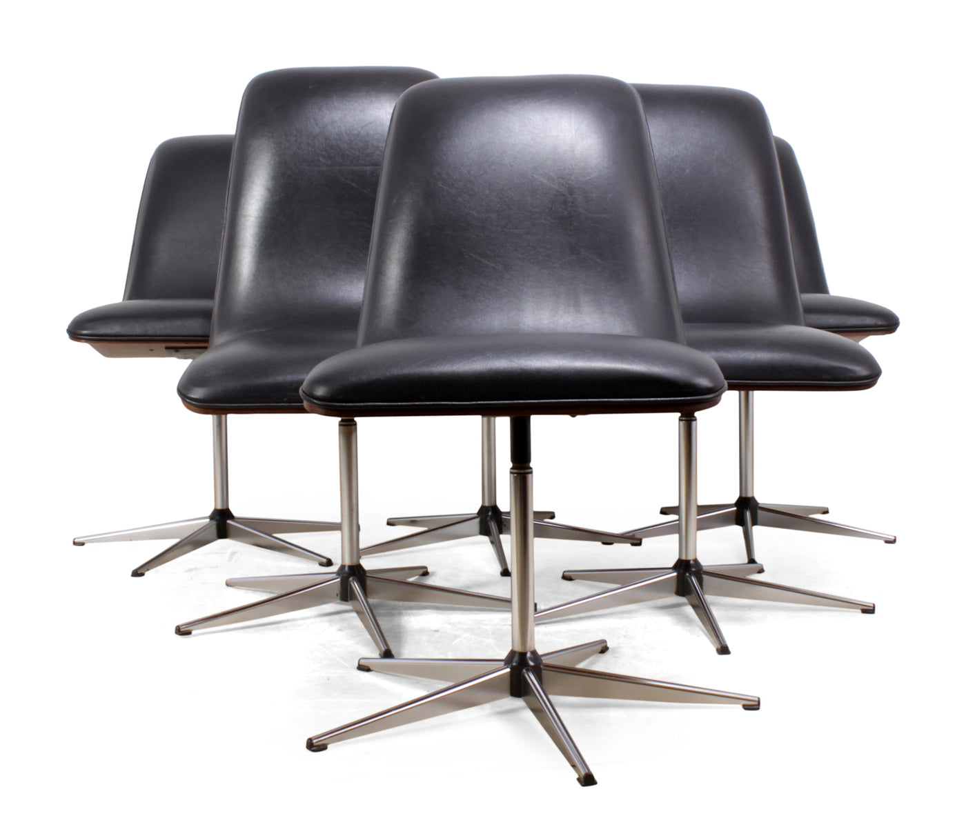 Designed in the late 50's by Robert heritage and produced by Archie Shine this set of six dining chairs have vinyl seats and bent ply rosewood backs sitting on chromed steel swivel bases, chairs are in overall good condition with one black plastic foot missing from one chair